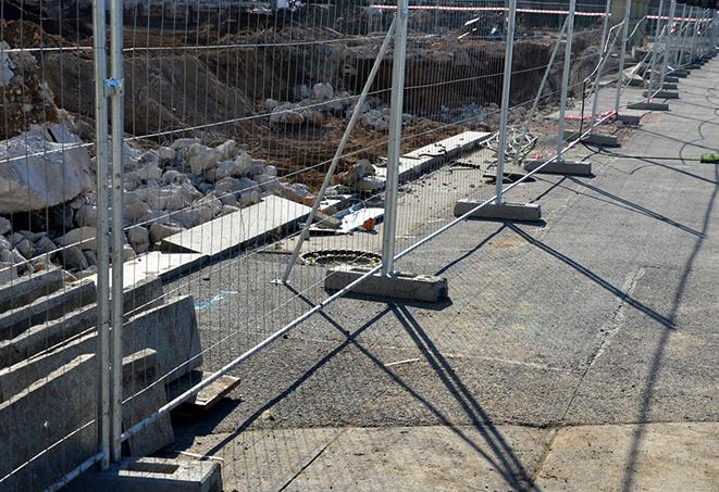 temporary fence panels lining a pathway for clear pedestrian access